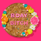 Festive birthday cookie cake with colorful frosting, sprinkles, and bold pink lettering spelling out
