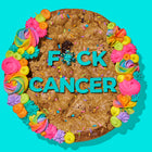 Chocolate chip cookie cake decorated with colorful frosting, sprinkles, and bold blue lettering that reads