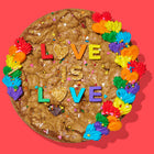 Rainbow-decorated pride cookie cake with colorful frosting, sprinkles, and bold lettering spelling out