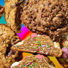 Specialty cookies delivery featuring an assortment of gourmet cookies with melted chocolate, sprinkles, and crispy cereal toppings.