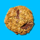 Oatmeal chocolate chip lactation cookie with gooey melted chocolate and a golden, chewy texture.