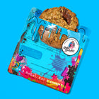 Gourmet oatmeal chocolate lactation cookie with melty chocolate chunks, partially wrapped in vibrant Rebel Daughter Cookies packaging.