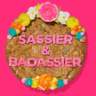 Decadent cookie cake with bright frosting, sprinkles, and bold pink lettering spelling out
