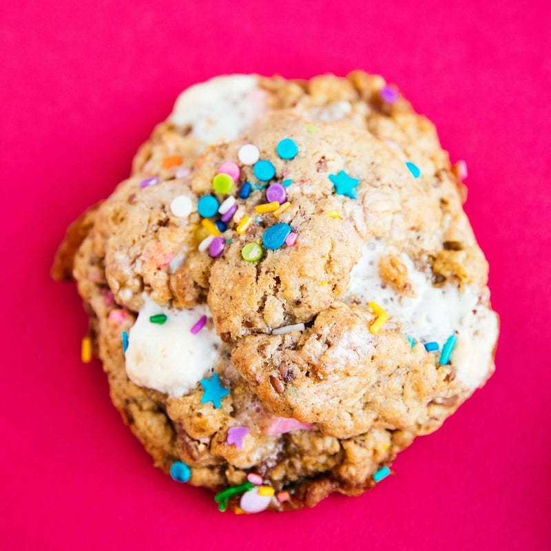 A Rebel Daughter Cookies Birthday Suit oatmeal lactation cookie with sprinkles on a pink background