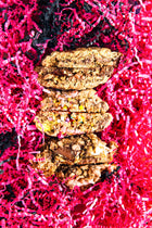 3 Rebel Daughter lactation cookies cut in half and stacked against pink crinkle paper