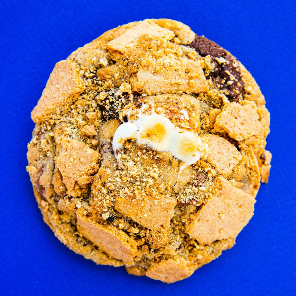 A Rebel Daughter Cookies gourmet chocolate chunk S'More, Please cookie against a royal blue background