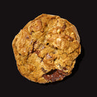 Chocolate and walnut gourmet cookies with a golden-brown exterior and melted chocolate chunks on a black background.