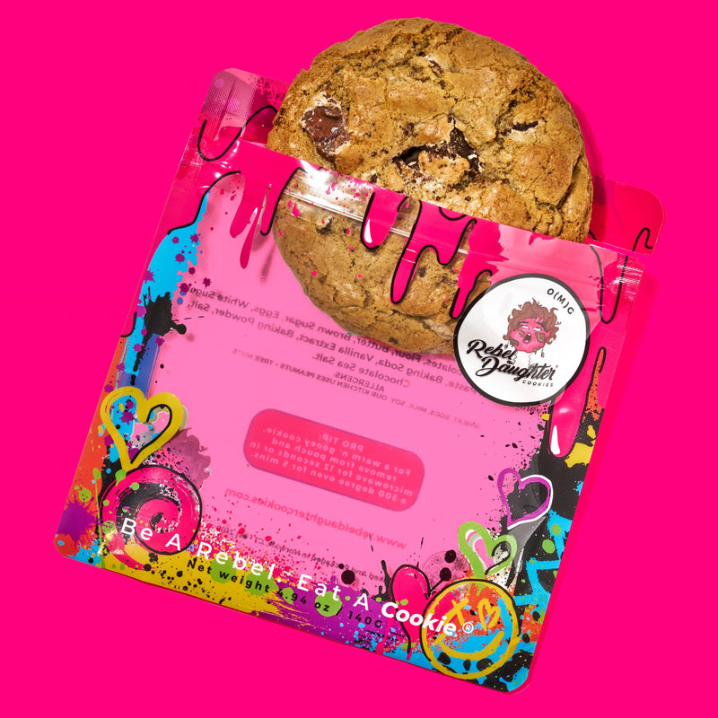 Chocolate specialty cookies delivered in vibrant, graffiti-style packaging with a golden-brown cookie peeking out on a pink background.