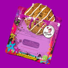 Cinnamon oatmeal raisin specialty cookies in vibrant packaging, featuring a drizzle of icing for a delicious, gourmet treat.