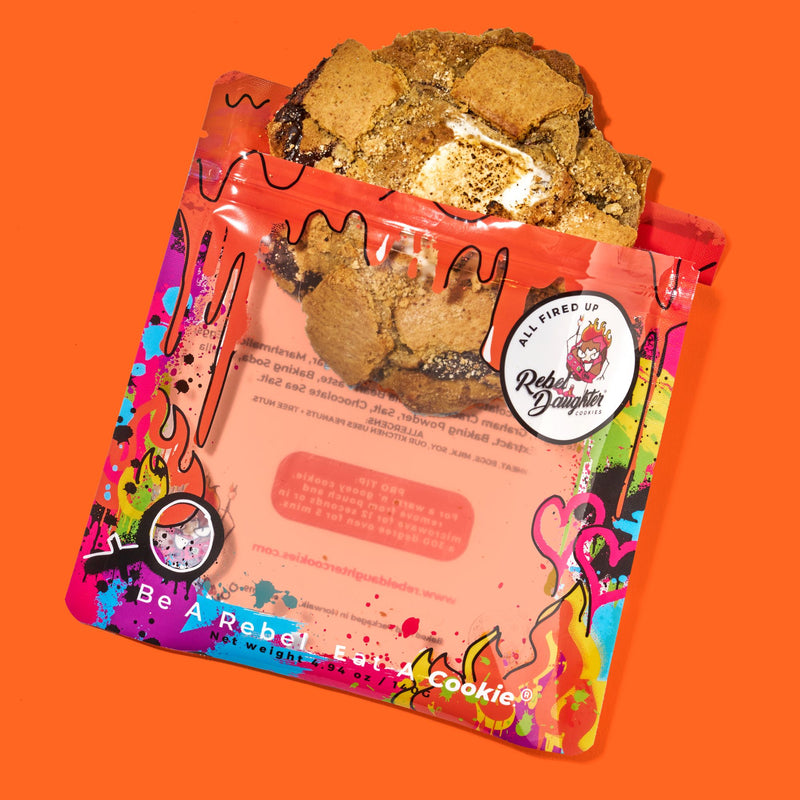 Decadent s'mores cookie with a toasted marshmallow center, rich melted chocolate, and crunchy graham cracker pieces in colorful packaging.