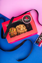 A pink Rebel Daughter Cookies delivery box showing 3 cookies