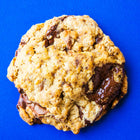 A Rebel Daughter oatmeal chocolate chunk lactation cookie against a blue background