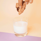 A gif of a Rebel Daughter oatmeal chocolate chunk lactation cookie being dunked into a glass of milk